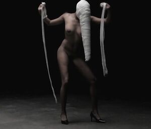 Weird concept music video of naked girls and men with strange stuff on heads excites